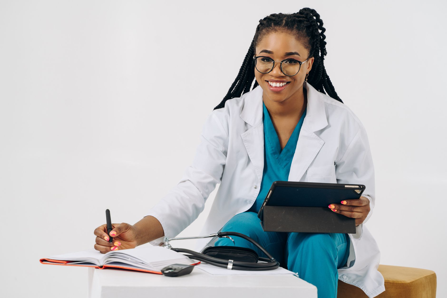 Una persona joven y atenta haciendo una videollamada con un médico, con una libreta y lápiz a su lado, simbolizando una consulta médica online bien preparada.